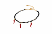 Bracciale oro perline nere 3 cornetti rossi - vista tre quarti