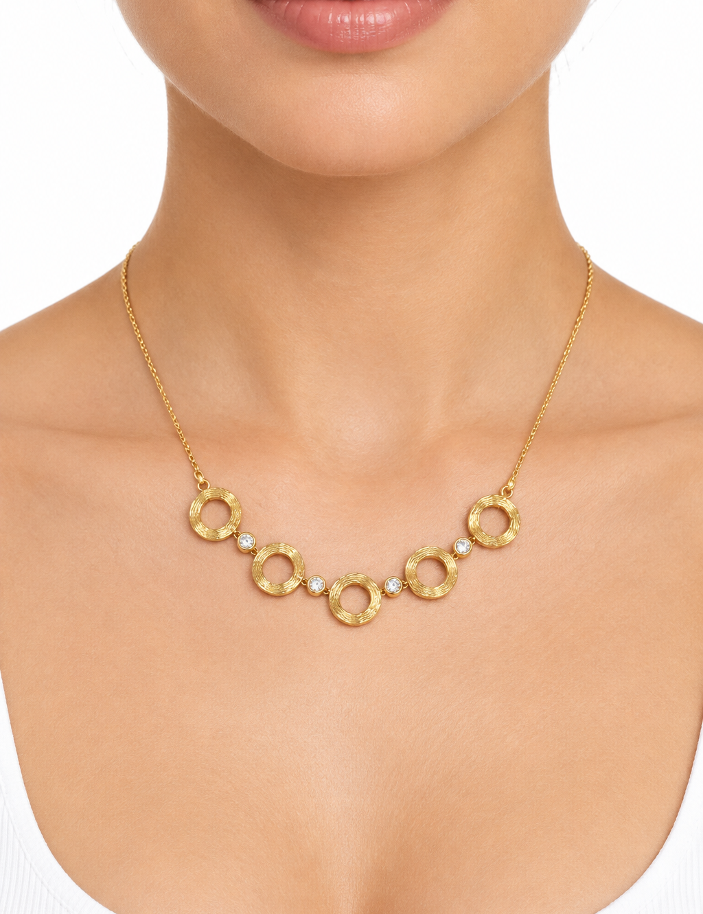 Collana dorata indossata su sfondo bianco